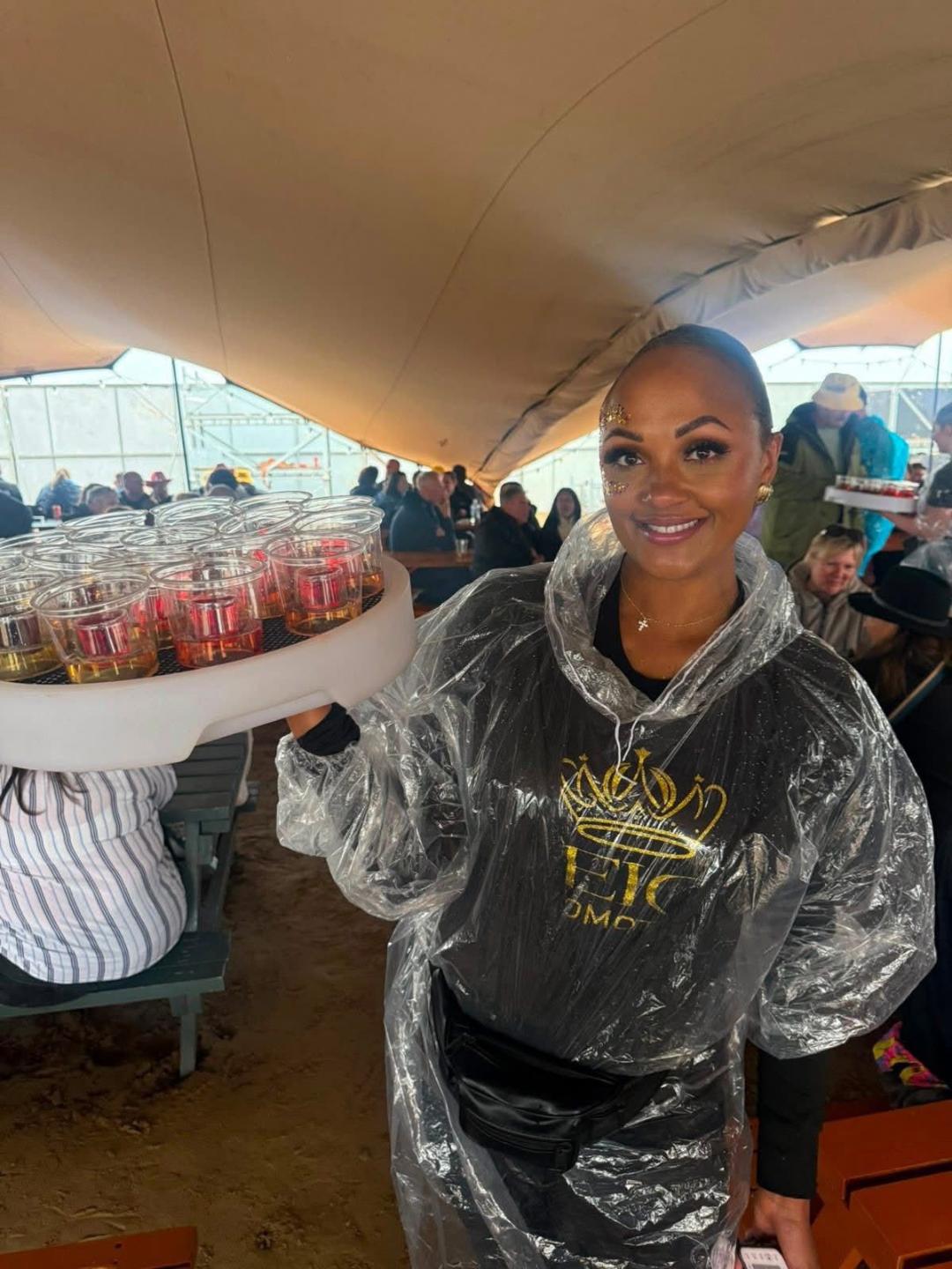 Reign shot seller with tray at a festival