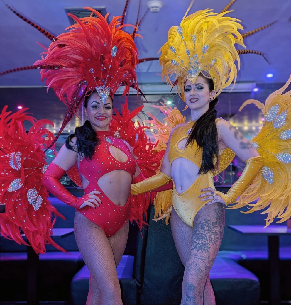 Reign Promotions feathered showgirl performers at a venue