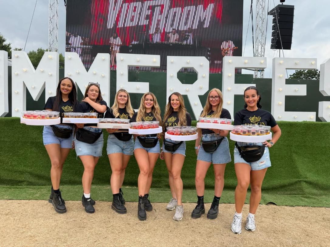 Reign Promotions team with shot trays at Summerfest main stage