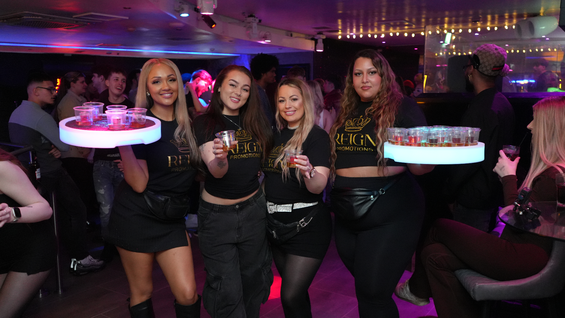 Reign Promotions team with LED shot trays in a nightclub