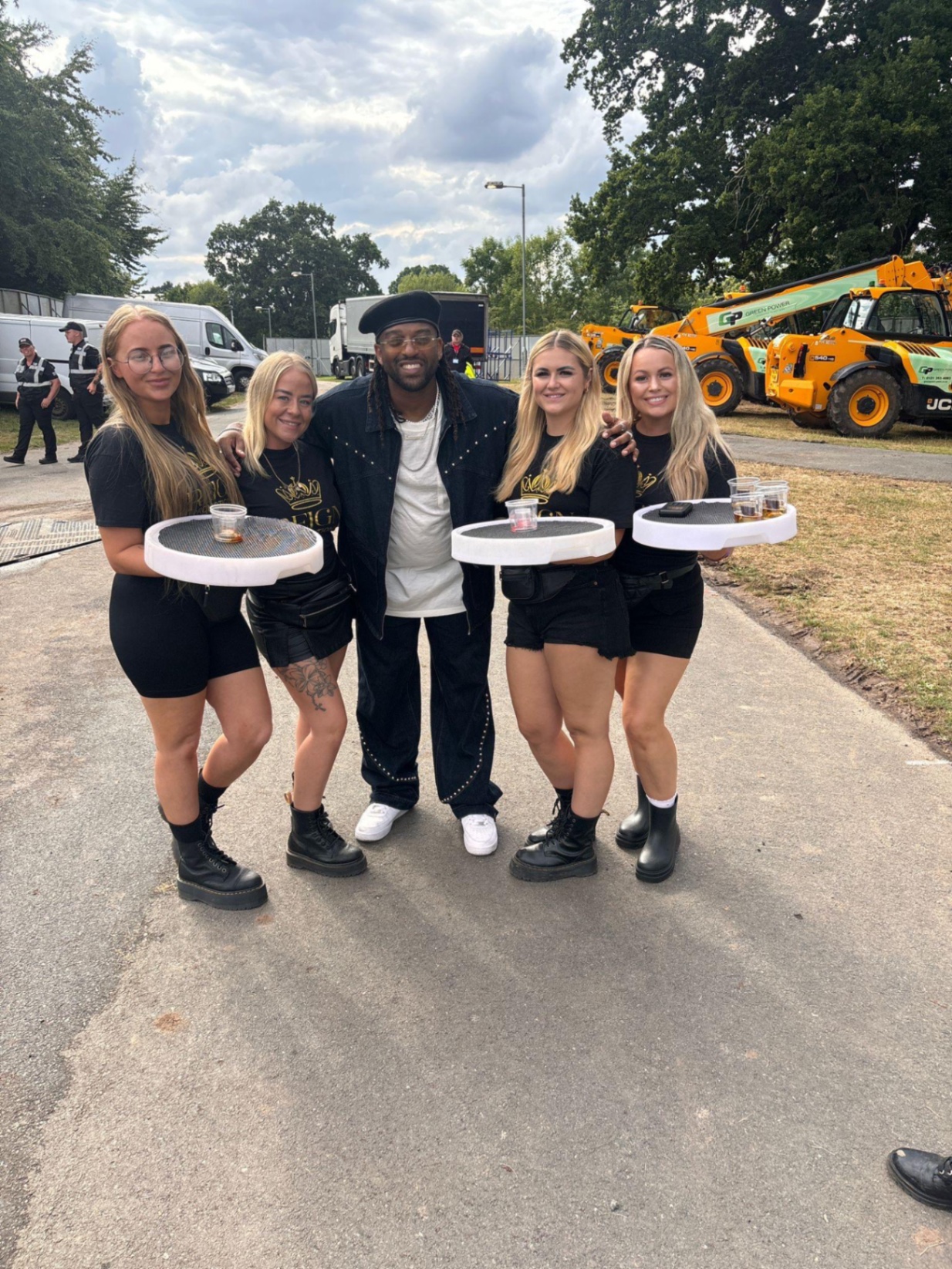 Reign team backstage with an artist at a festival