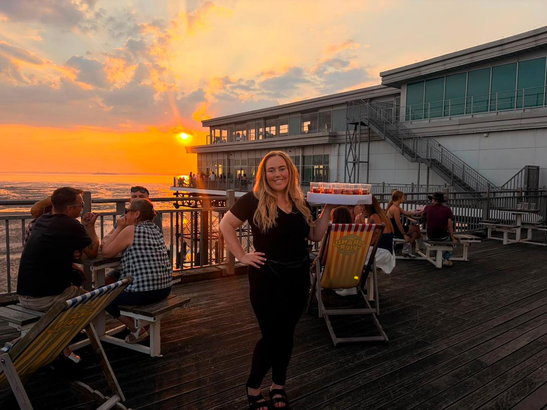 Reign shot seller at Grand Pier against a sunset sky