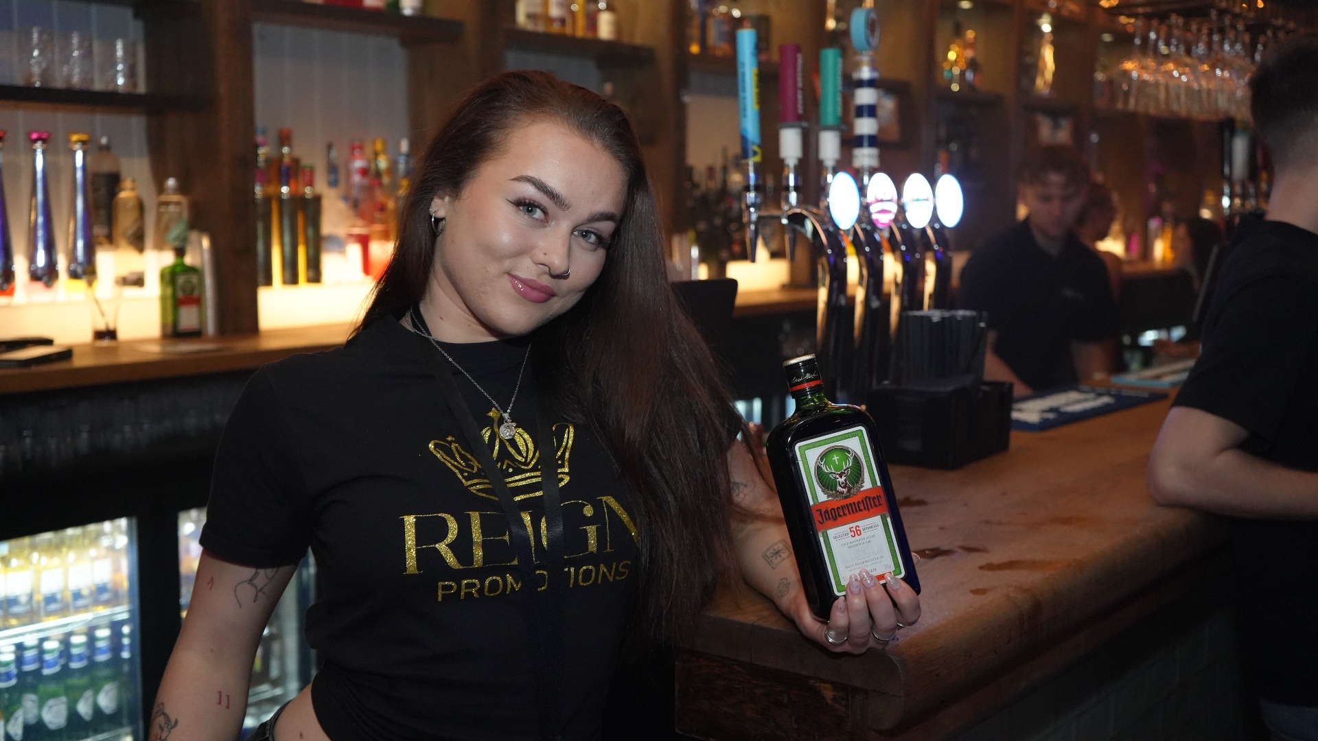 Reign shot seller with a Jägermeister bottle at the bar