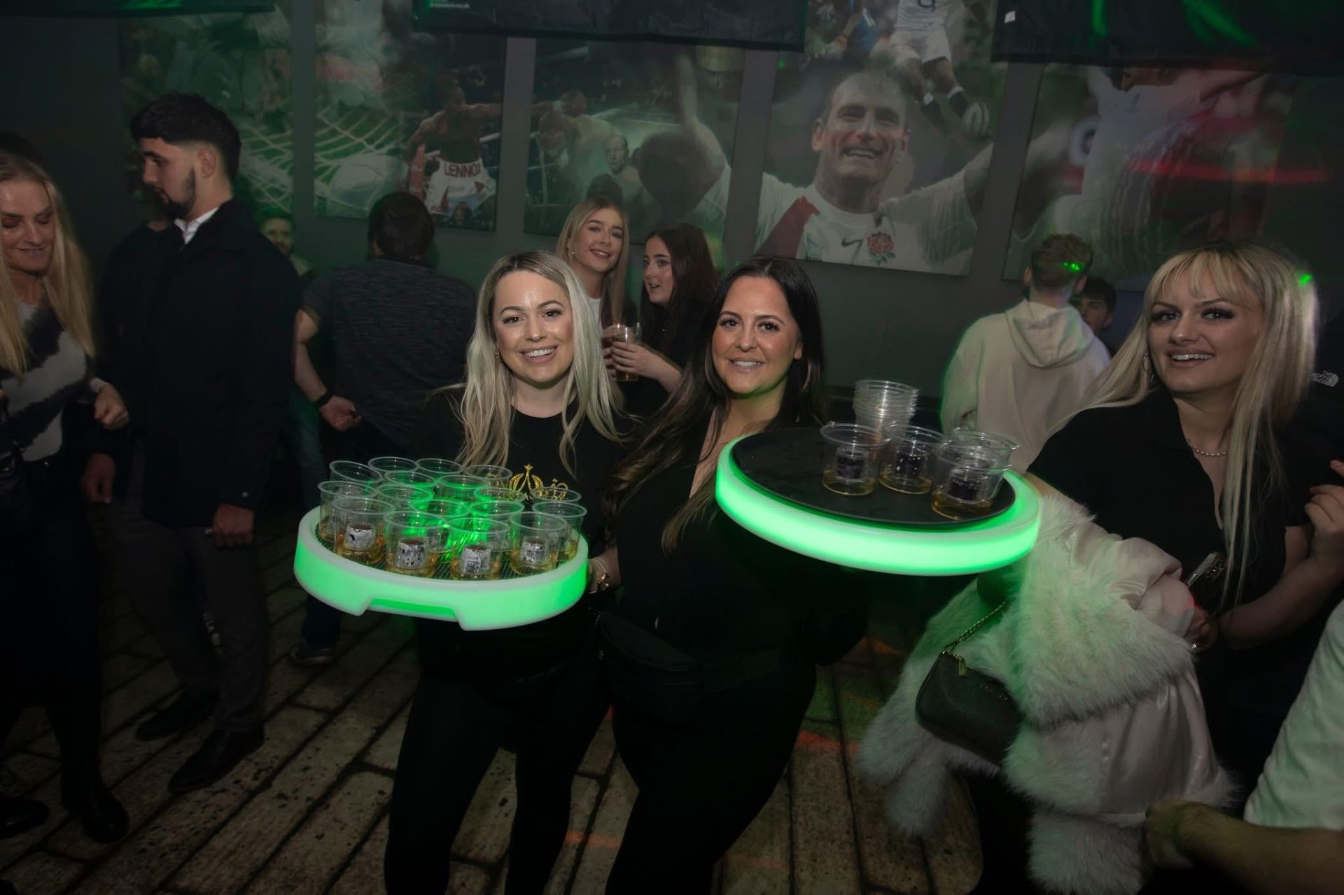 Reign shot sellers with LED trays at a sports bar