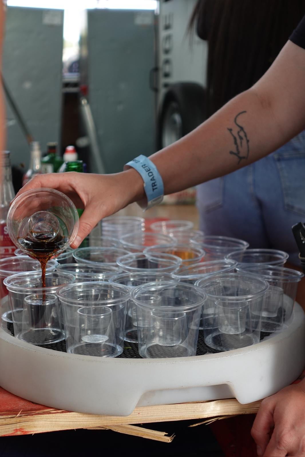 Reign shot seller pouring Jägermeister into shot tray cups